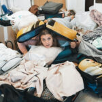 woman in pile of house clutter