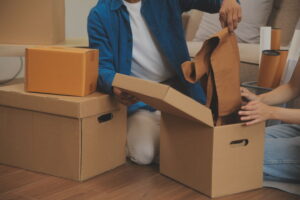 couple packing up their sensitive items into boxes for summer storage