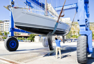 man cleaning and washing his boat getting it ready for storage